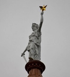 Red Tailed Hawk Perched on Lady Liberty atop Texas Capitol in Austin